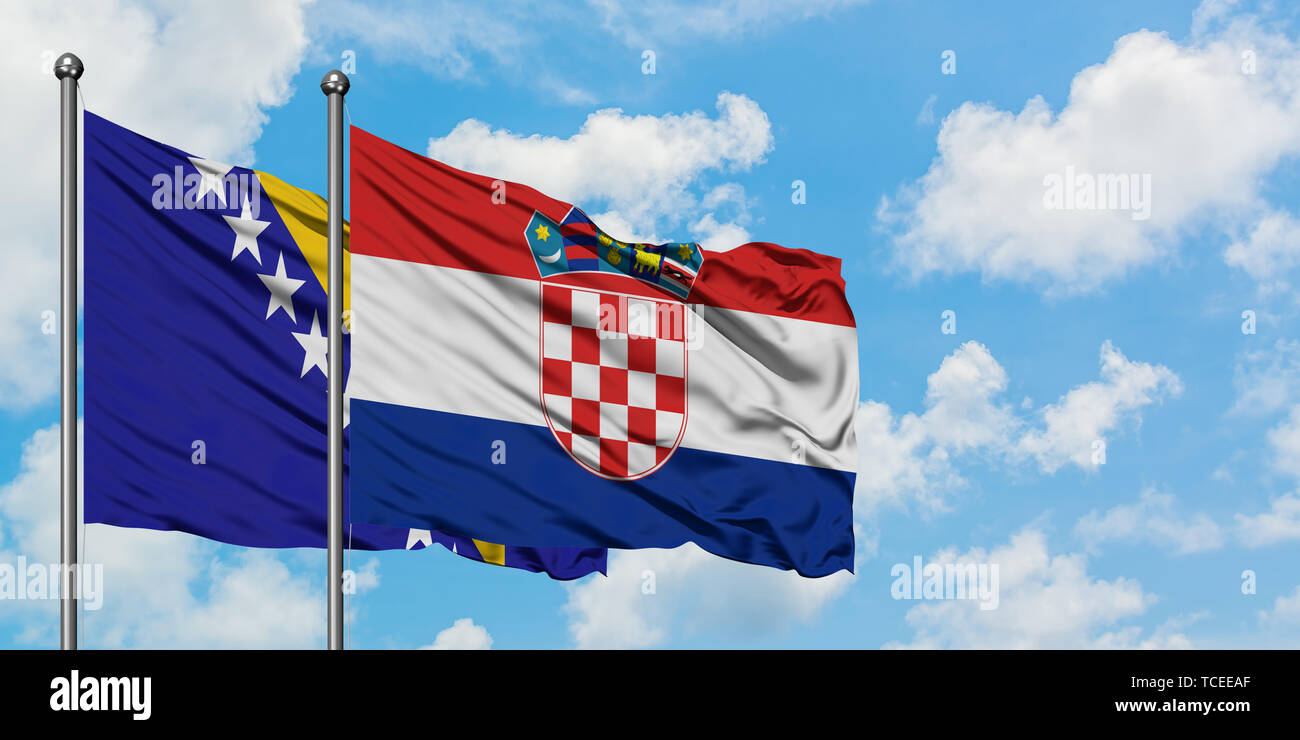 Bosnia Herzegovina and Croatia flag waving in the wind against white cloudy blue sky together. Diplomacy concept, international relations. Stock Photo