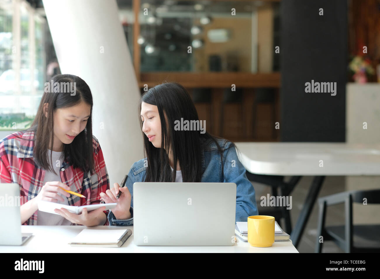 girl teenager studying with computer laptop. college high school student taking note Stock Photo