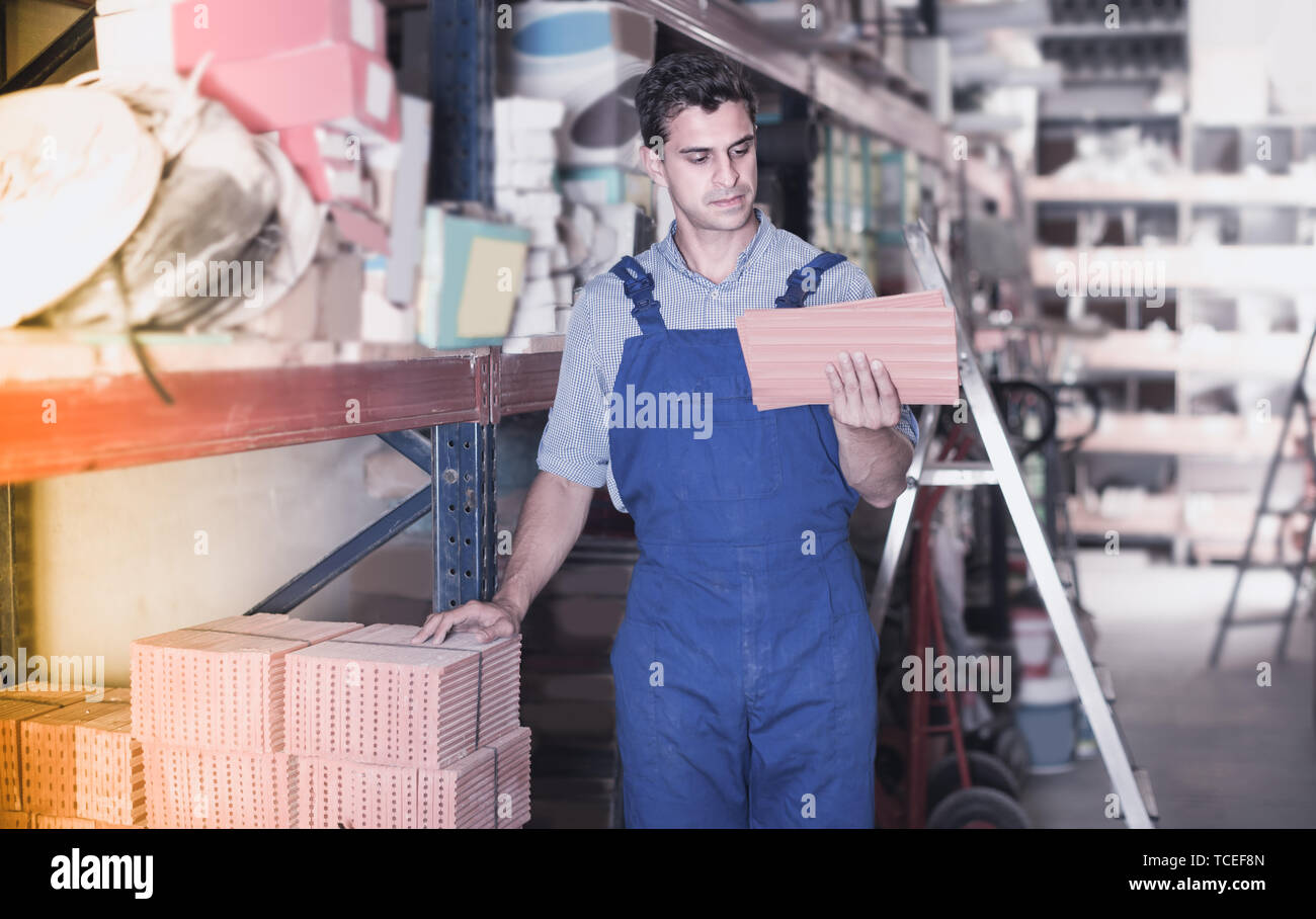 Builder is choosing tiles in the building store. Stock Photo
