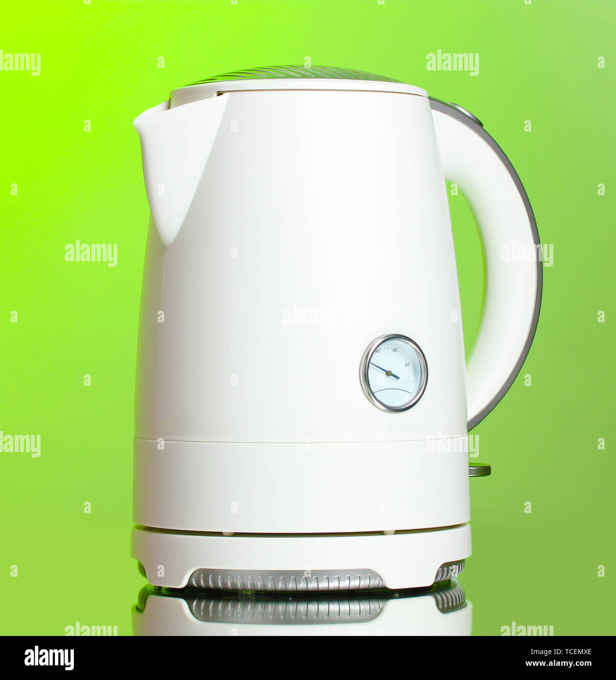 https://c8.alamy.com/comp/TCEMXE/white-electric-kettle-on-green-TCEMXE.jpg