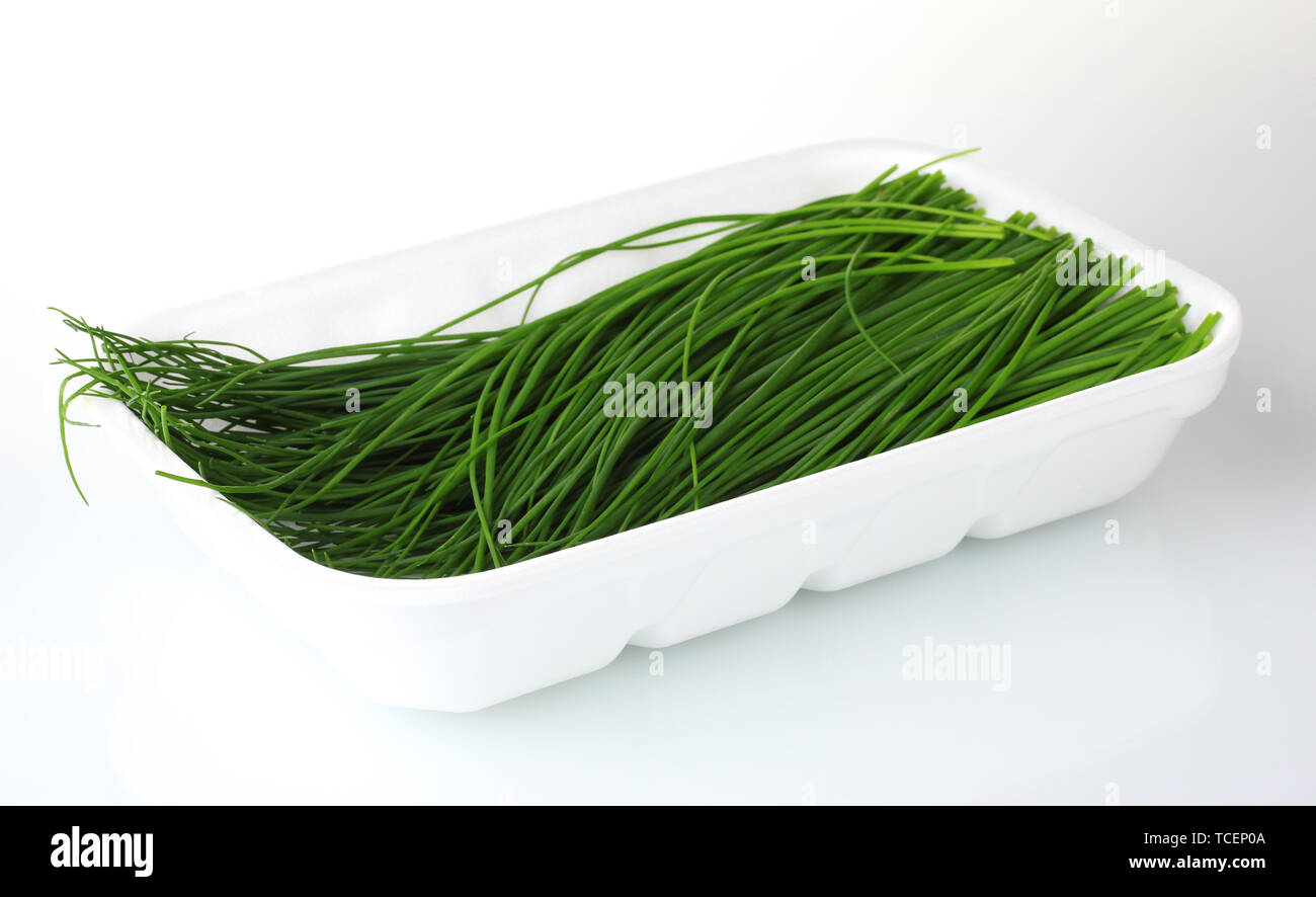 beautiful green onion chives in package isolated on white Stock Photo