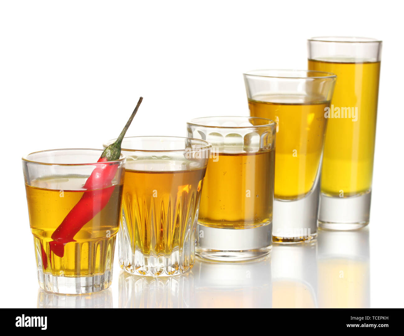glasses of pepper vodka and red chili pepper isolated on white Stock