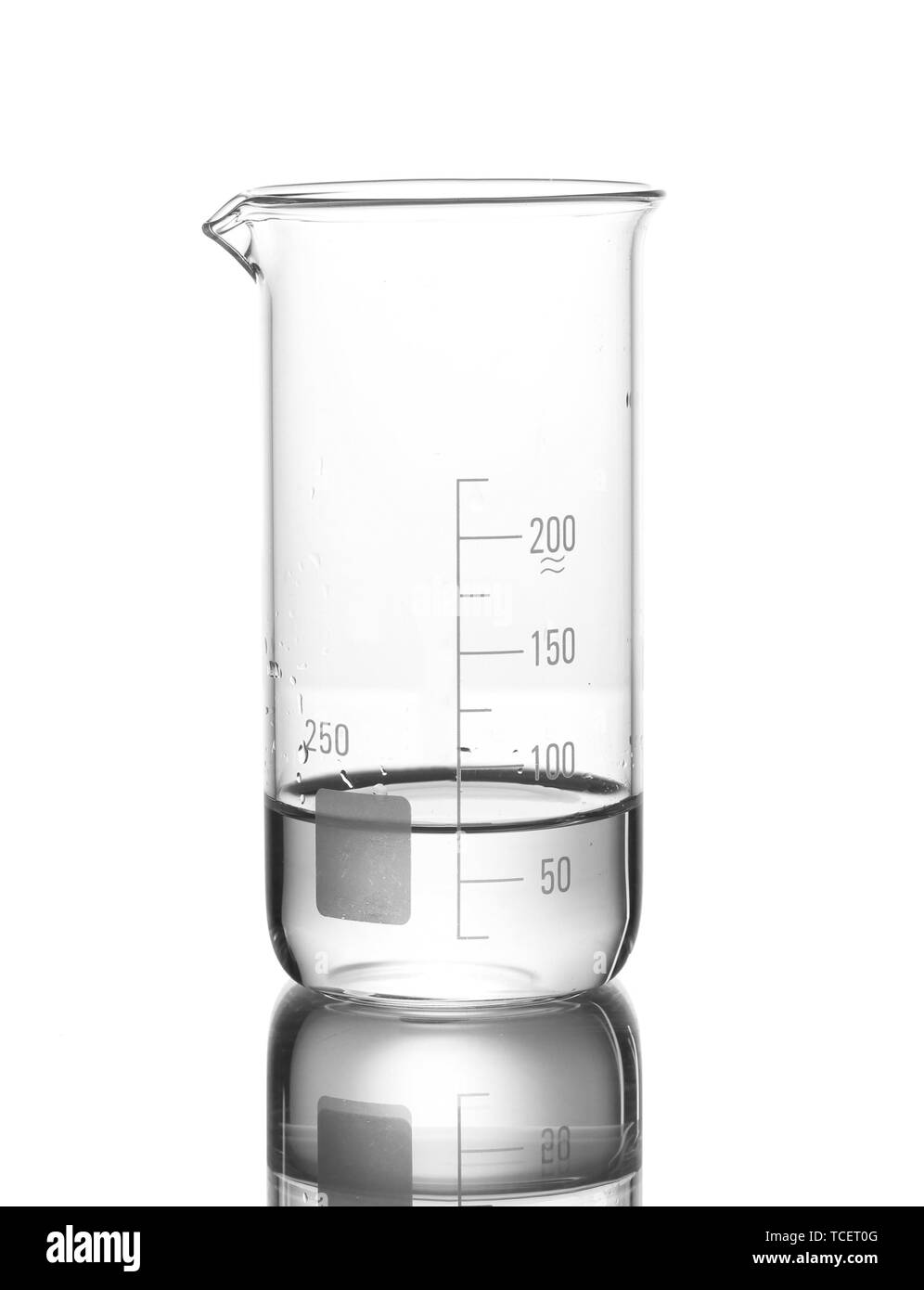 Measuring beaker with water and reflection isolated on white Stock Photo