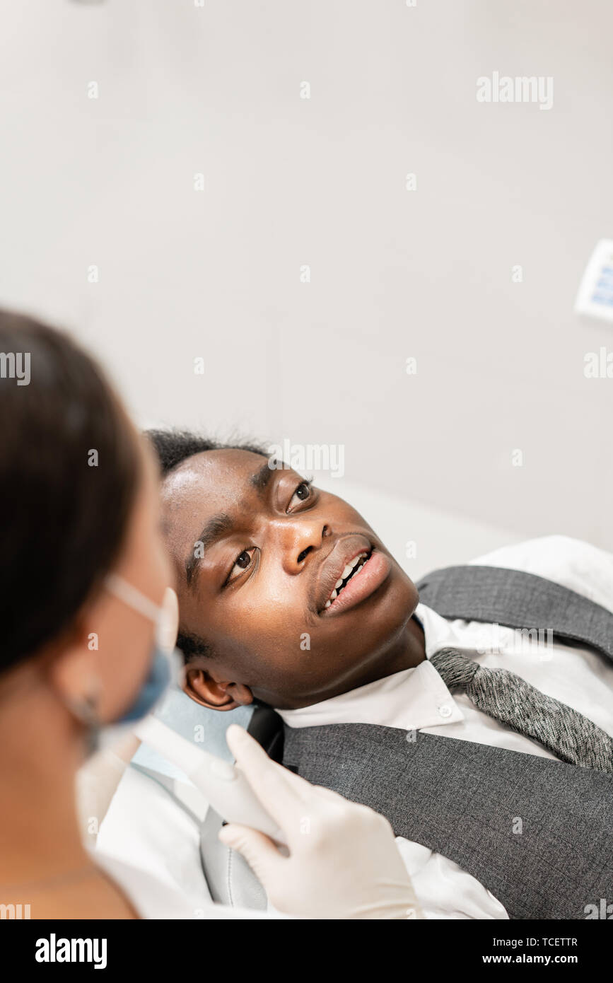 Young woman dentist treating root canals in the dental clinic. Young