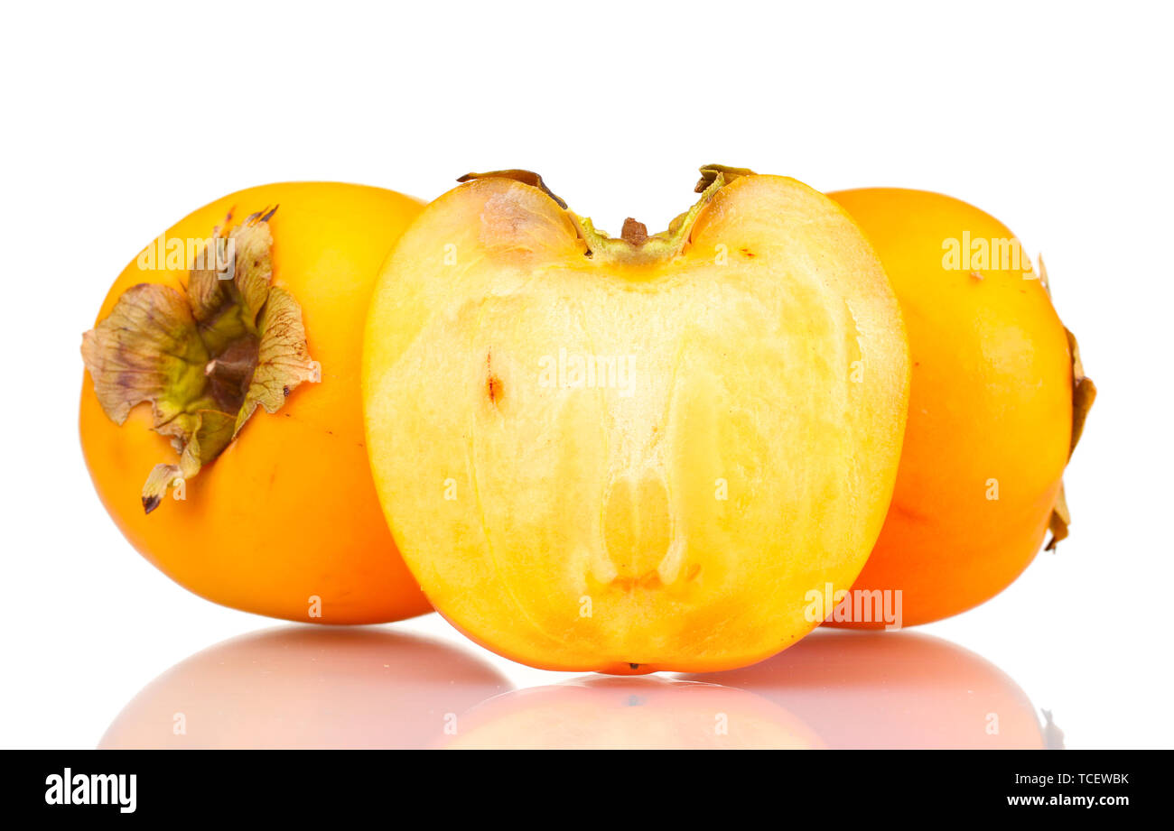 Two and half appetizing persimmons isolated on white Stock Photo