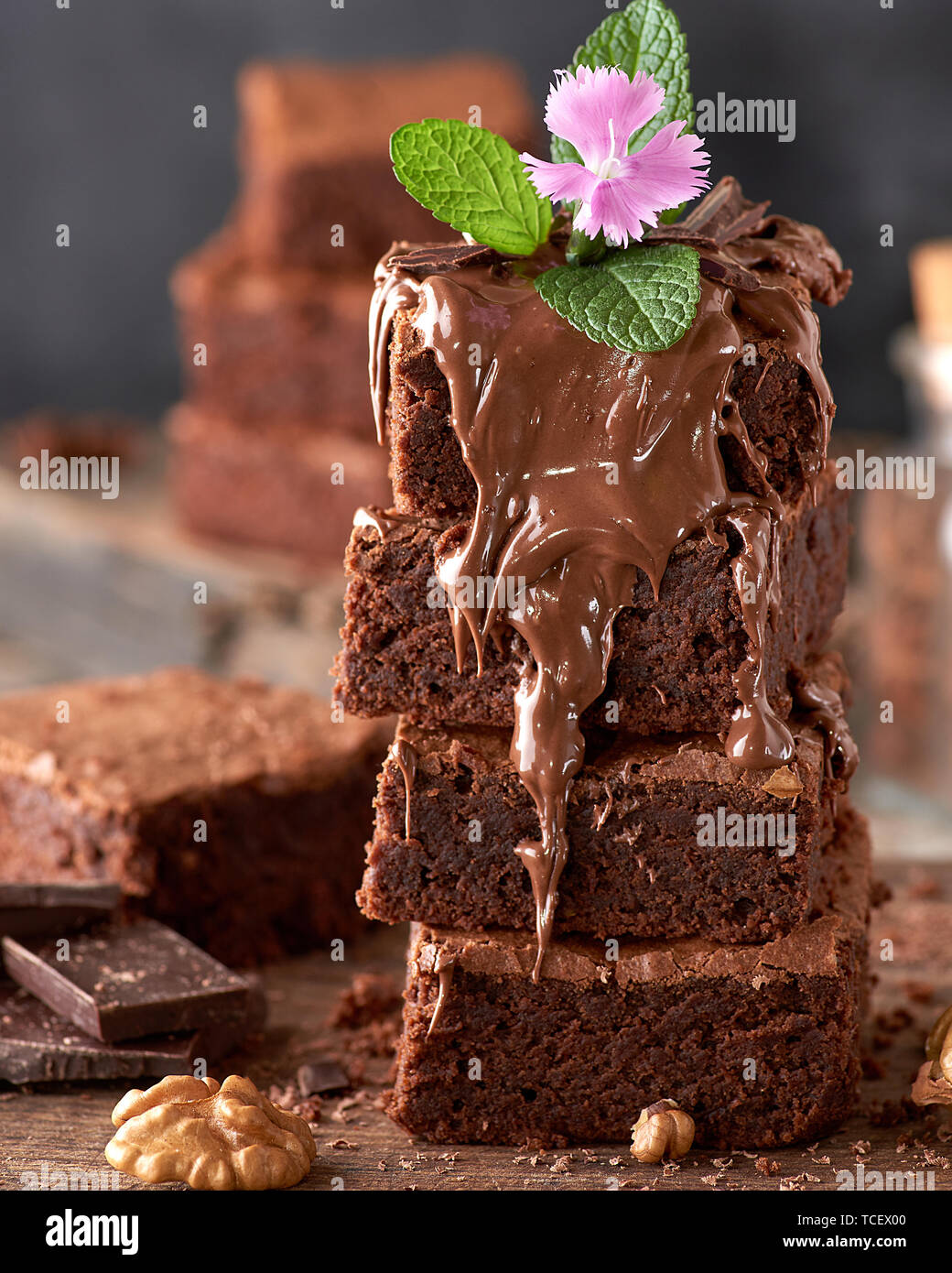 stack of square pieces of baked brownie chocolate poured on brown wooden board, close up Stock Photo