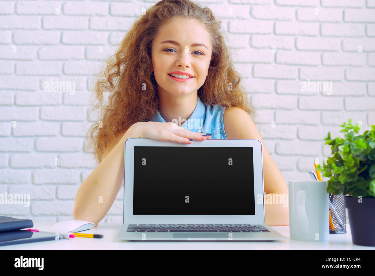 Beautiful caucasian woman sitting and working on laptop Stock Photo - Alamy