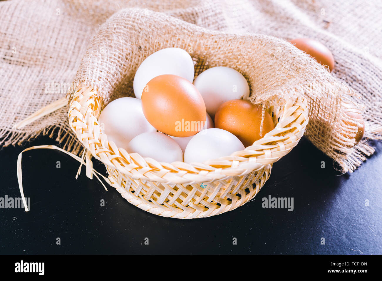 Eggs on tablecloth over black background Stock Photo