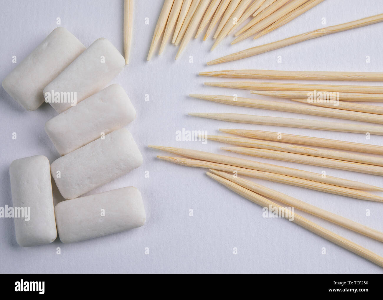 Toothpicks and chewing gum on white background Stock Photo Alamy