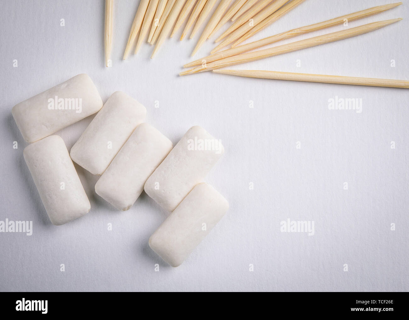 Toothpicks and chewing gum on white background Stock Photo Alamy