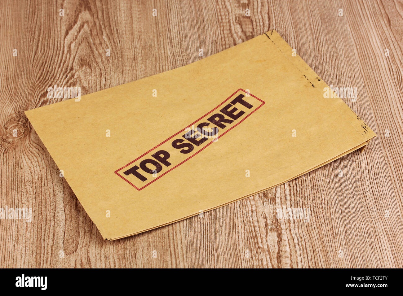 Envelope with top secret stamp on wooden background Stock Photo