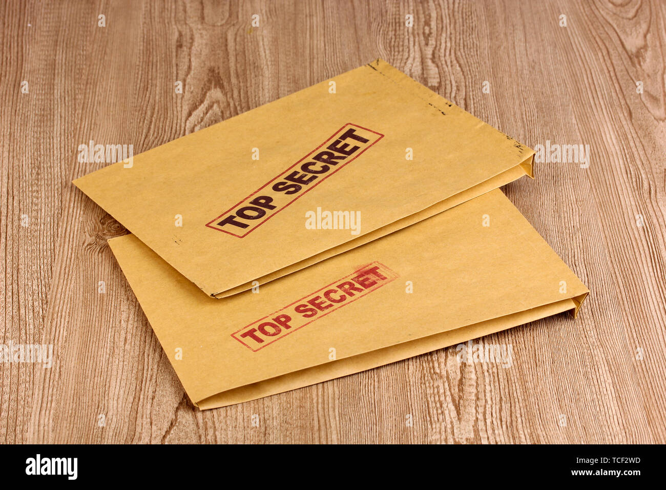 Envelopes with top secret stamp on wooden background Stock Photo