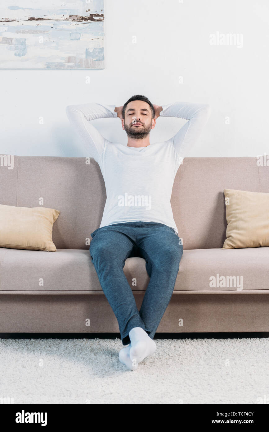 Resting Back handsome bearded man with eyes closed and Hands Behind Back resting on ...