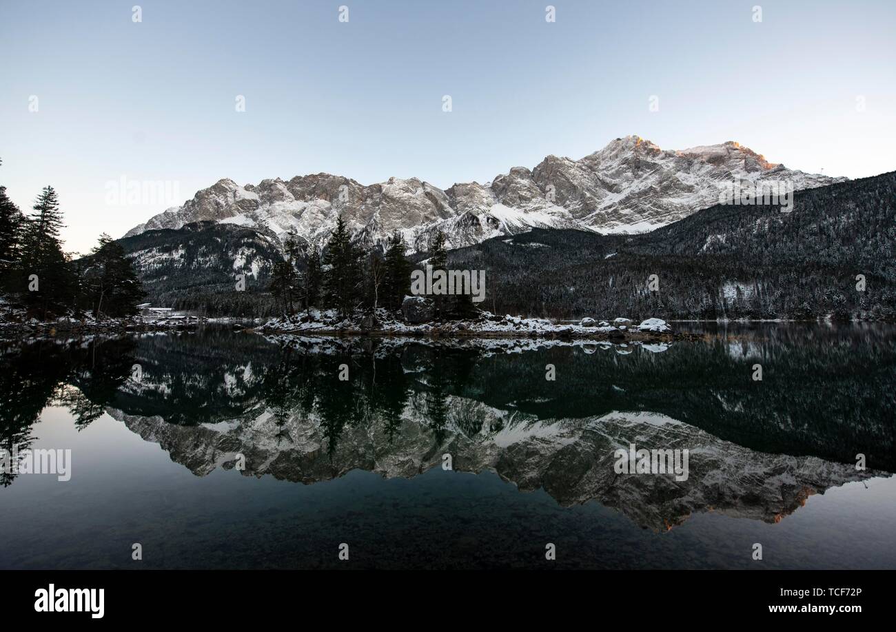 Lake Eibsee in winter with snow-covered Zugspitze, water reflection, Wetterstein range, Grainau, Upper Bavaria, Bavaria, Germany, Europe Stock Photo