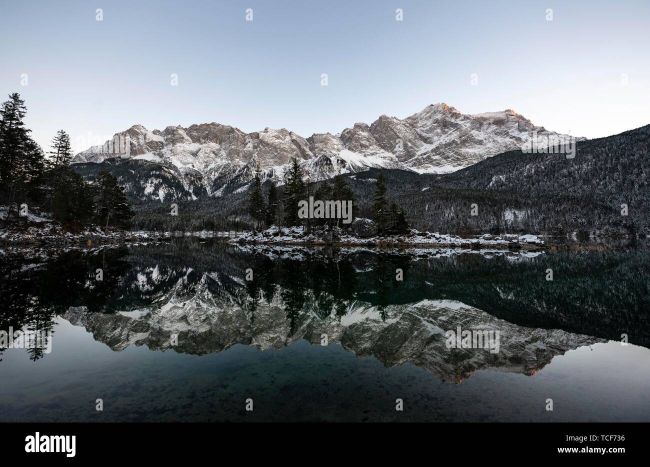 Lake Eibsee in winter with snow-covered Zugspitze, water reflection ...