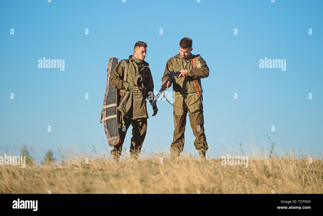 Hunter friend enjoy leisure in field. Hunting with friends hobby
