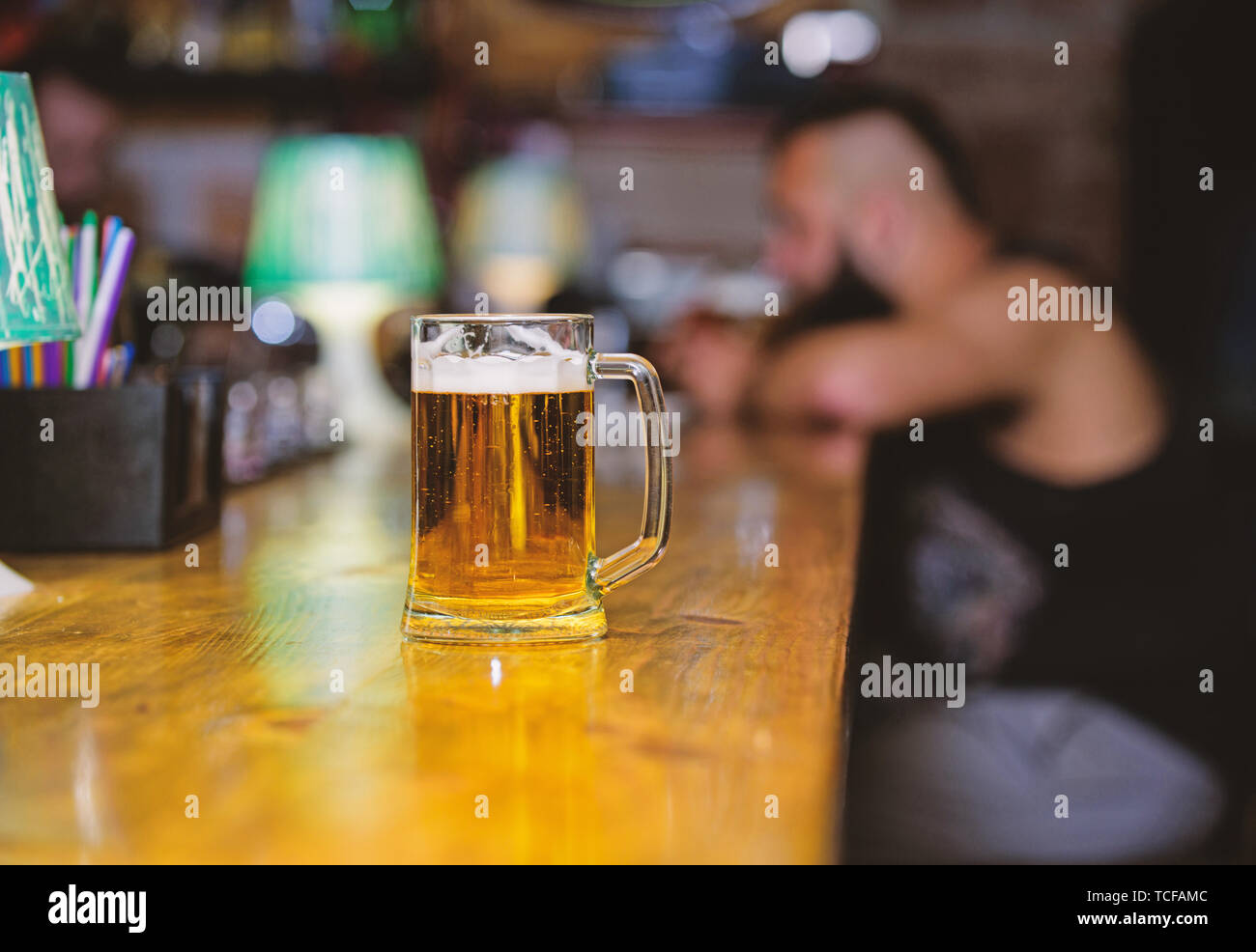 Glass with fresh lager draft beer with foam. Mug filled with cold tasty