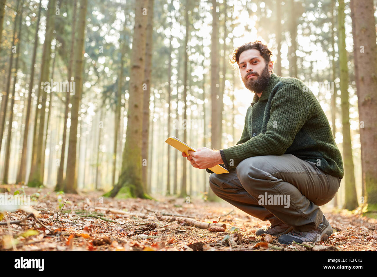 Young forester with checklist in forestry for sustainable forestry Stock Photo