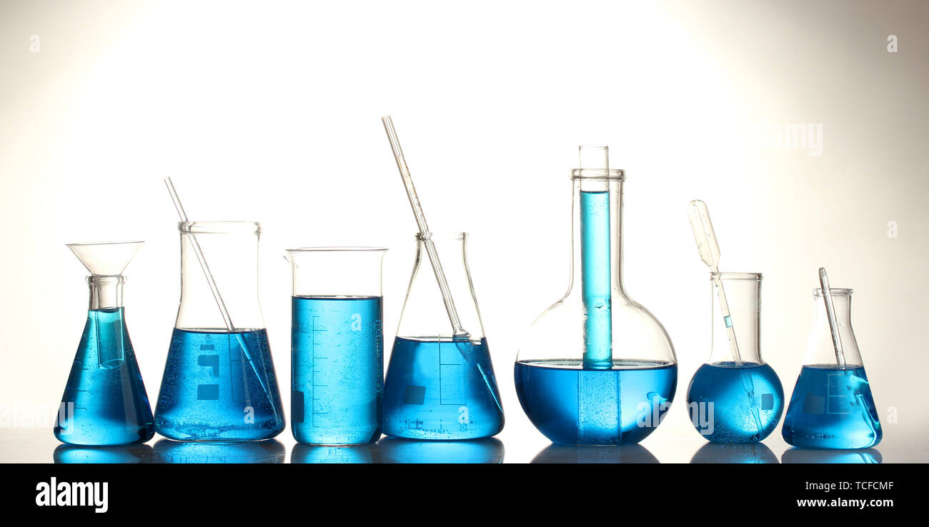 Test-tubes with blue liquid isolated on white Stock Photo - Alamy