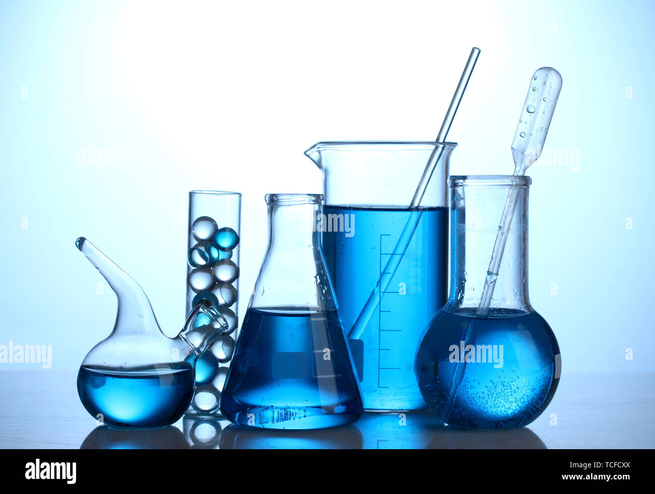 Test-tubes with blue liquid on blue background Stock Photo - Alamy
