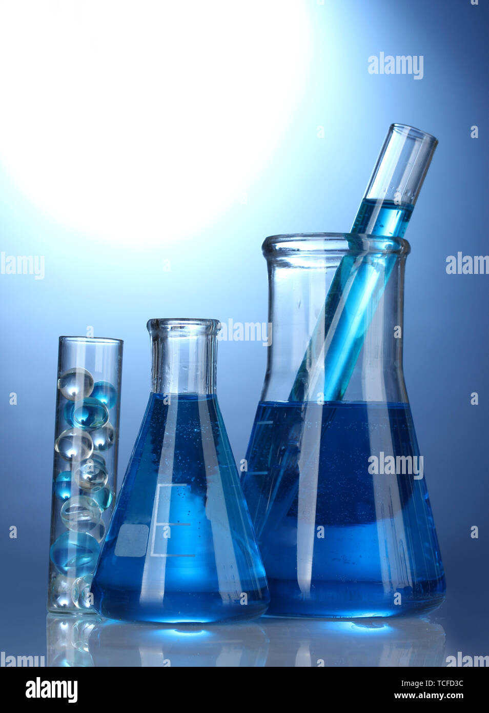 Test-tubes with blue liquid on blue background Stock Photo - Alamy