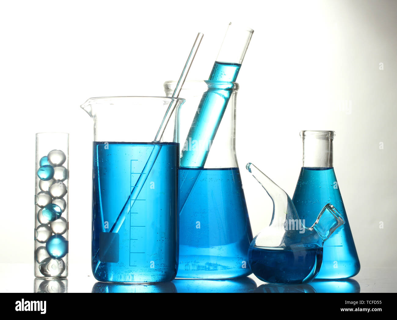 Test-tubes with blue liquid isolated on white Stock Photo - Alamy