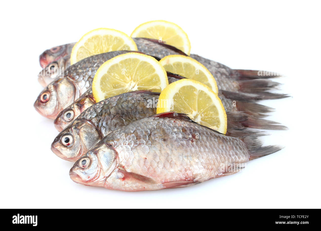 Fresh fishes with lemon isolated on white Stock Photo Alamy