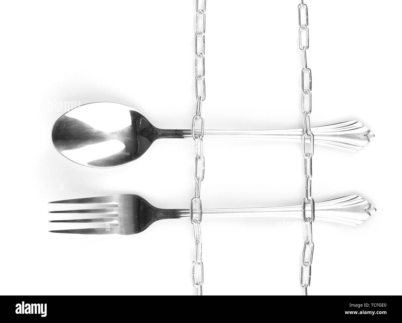 Fork and spoon with chain isolated on white Stock Photo Alamy