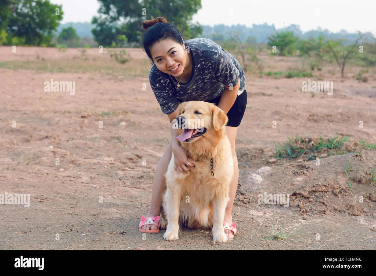 Woman with her golden retriever dog playing outdoors Stock Photo - Alamy