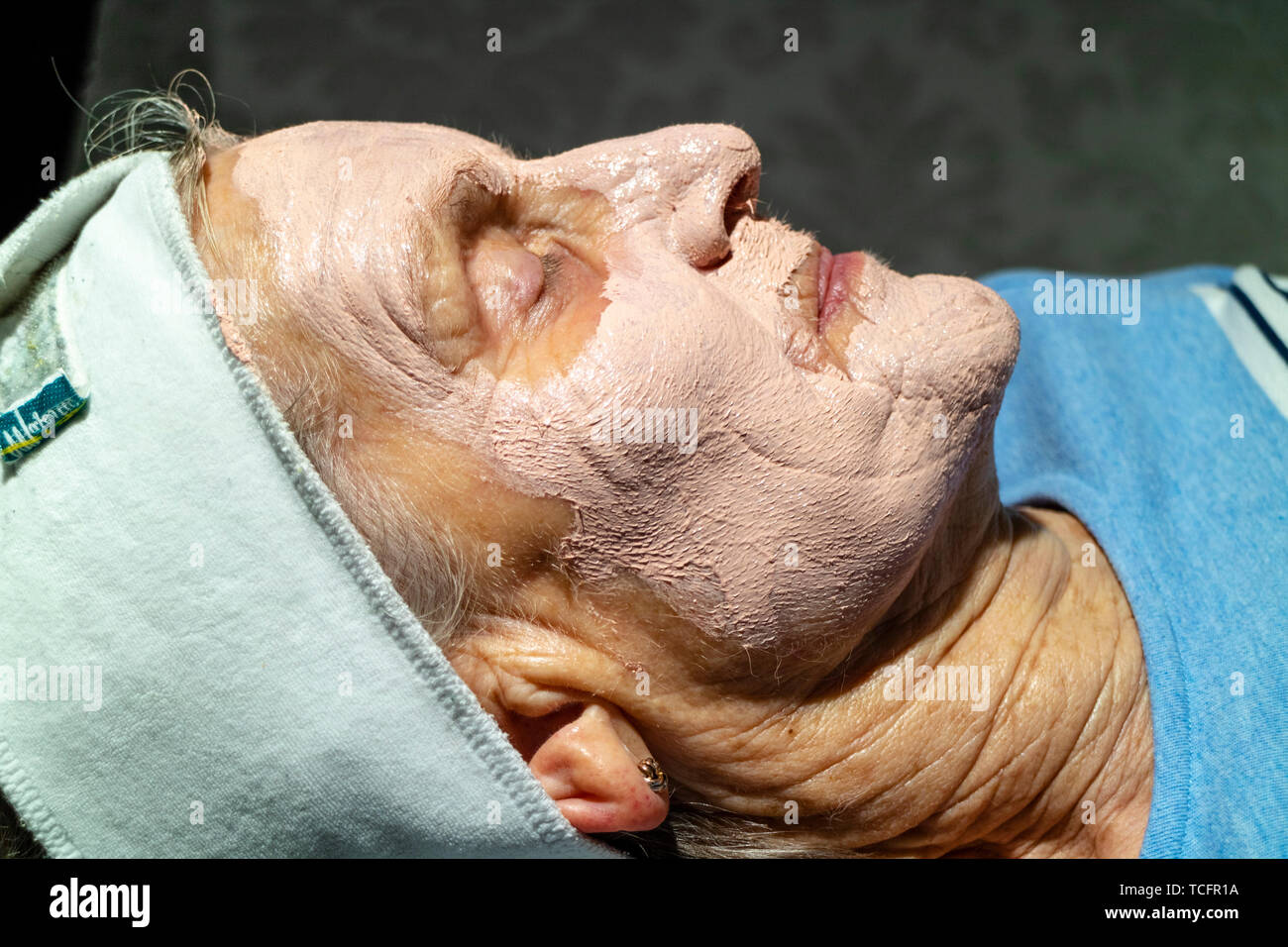Berkshire, UK. June 2019. An elderly woman's face during facial beauty treatment. Stock Photo