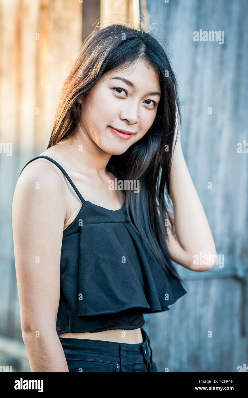 A beautiful Thai girl poses at the famous tourist landmark Pae Gate, Chiang Mai, Thailand. Stock Photo