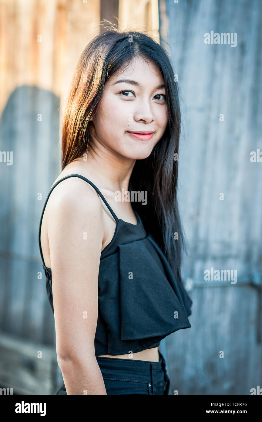 a beautiful thai girl poses at the famous tourist landmark pae gate chiang mai thailand TCFR76