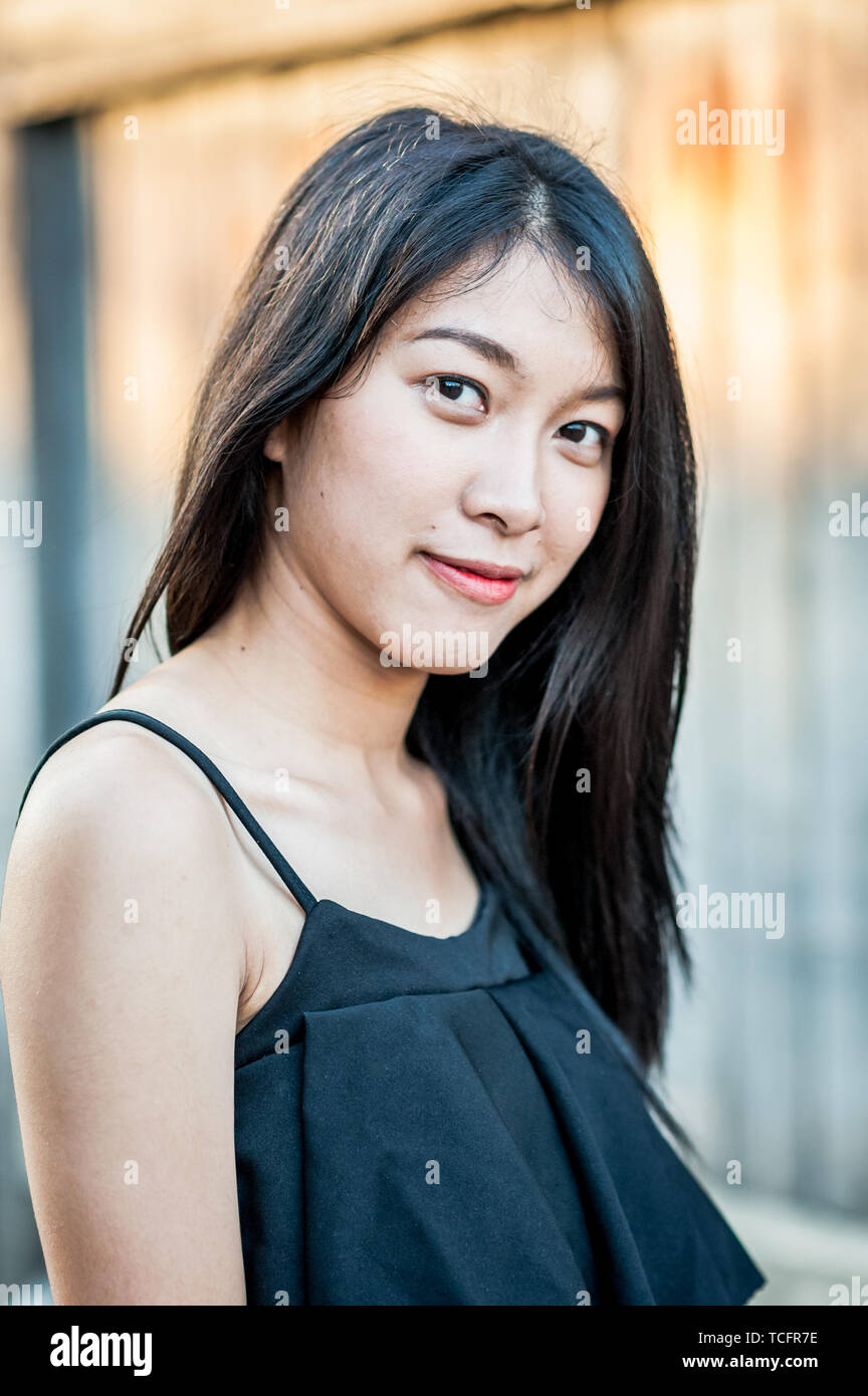 A beautiful Thai girl poses at the famous tourist landmark Pae Gate, Chiang Mai, Thailand. Stock Photo