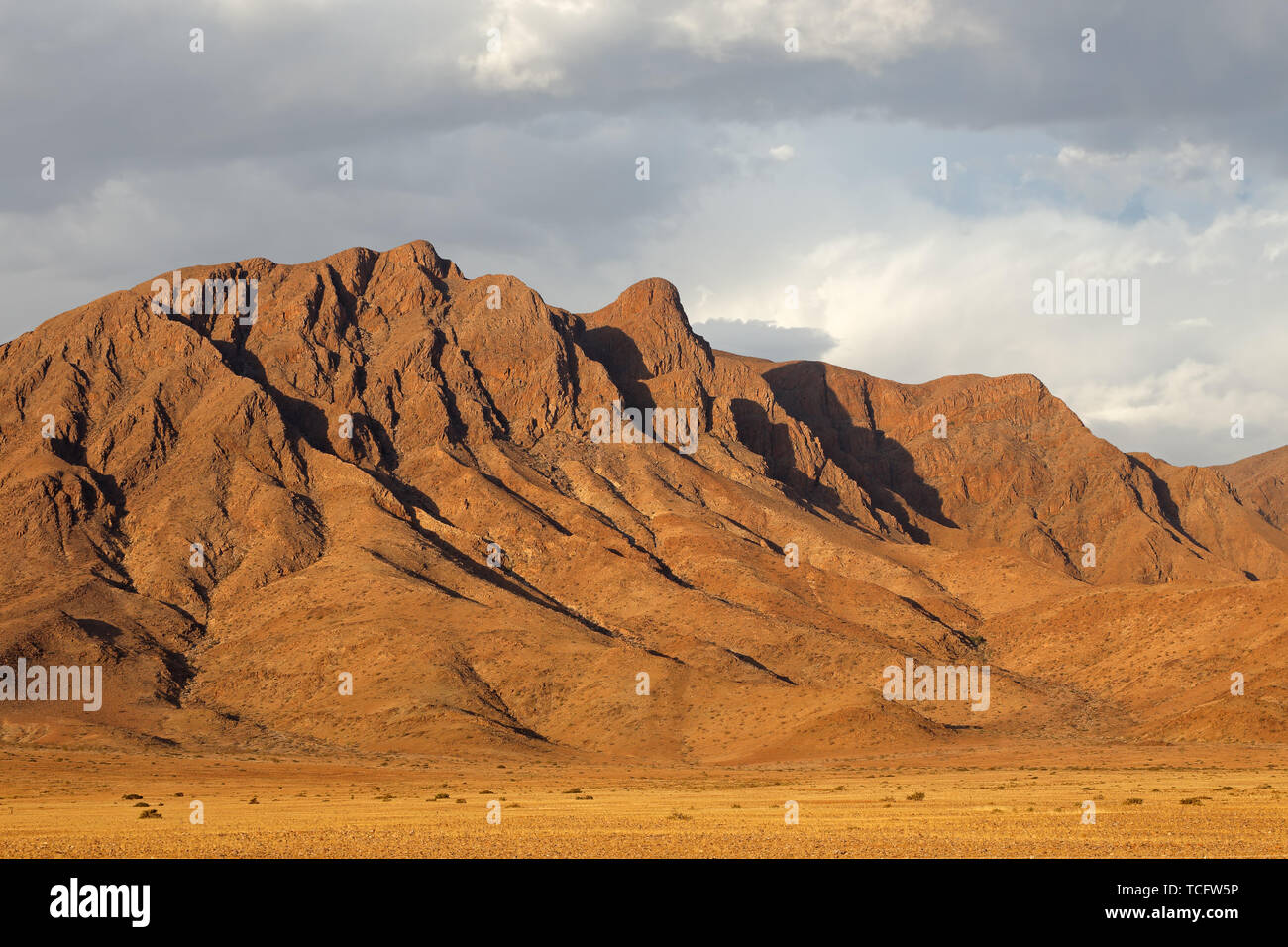 Rugged mountain landscape with cloudy sky, Namib desert, Namibia Stock Photo