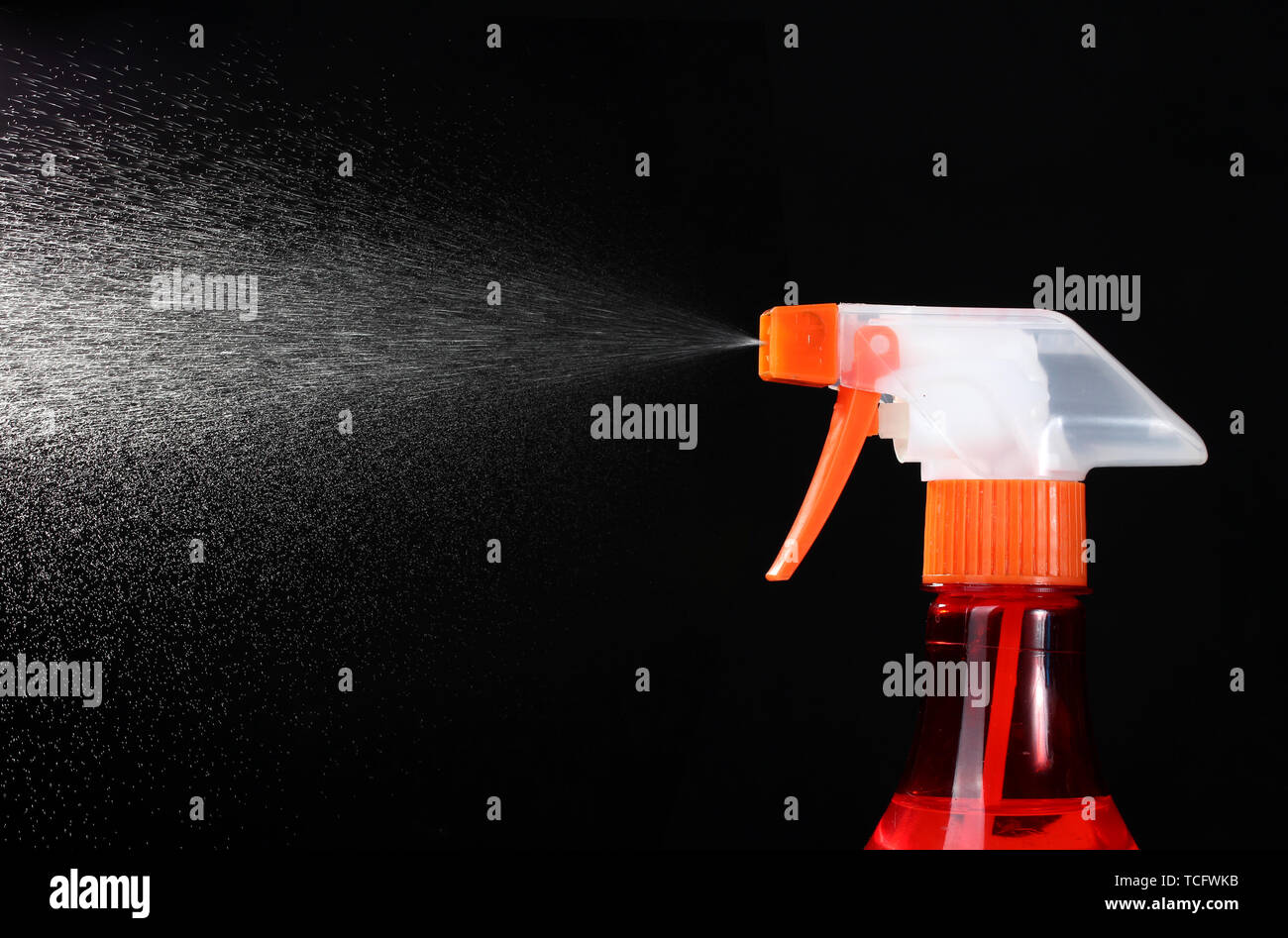 spray bottle and spraying on black background Stock Photo - Alamy