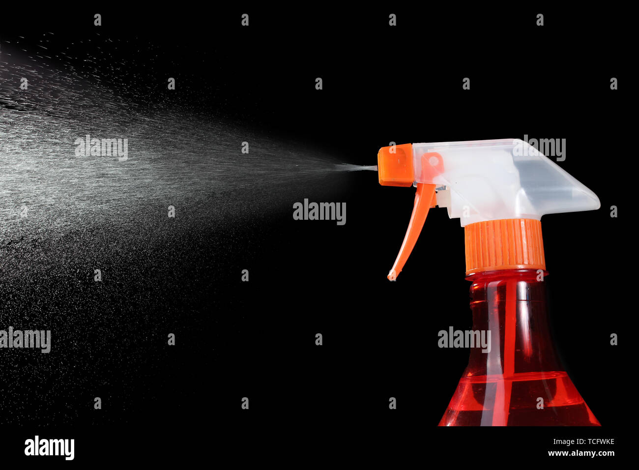 spray bottle and spraying on black background Stock Photo - Alamy