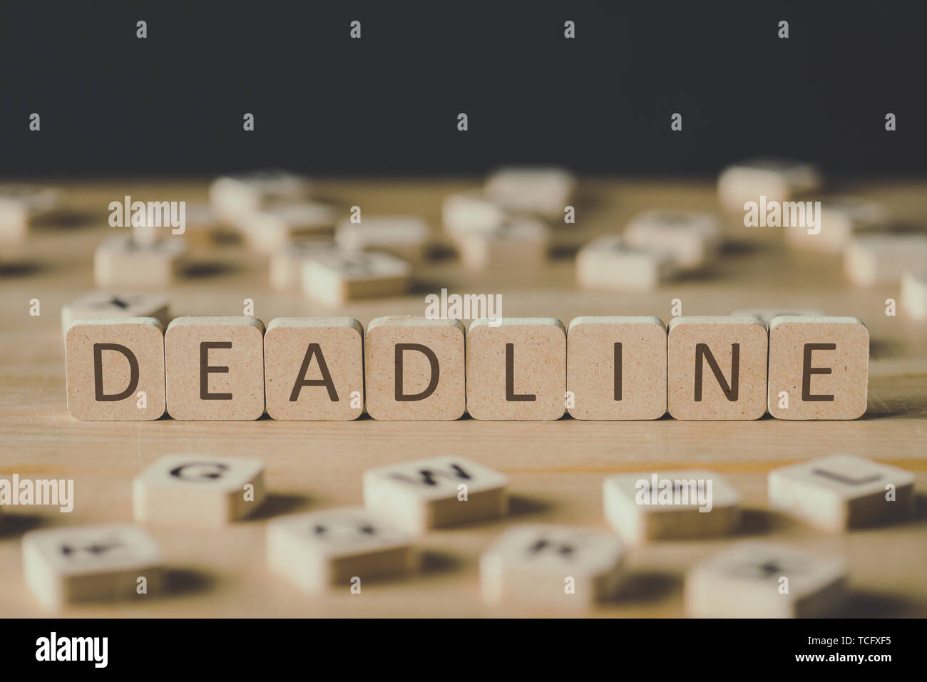 selective focus of word deadline made of cubes surrounded by blocks ...