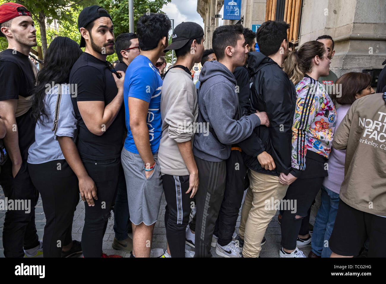 Barcelona, Catalonia, Spain. 7th June, 2019. A group of young people stand  in a queue to access the purchase of the new Adidas Yeezy Boost shoe.The  German manufacturer of sports shoes Adidas