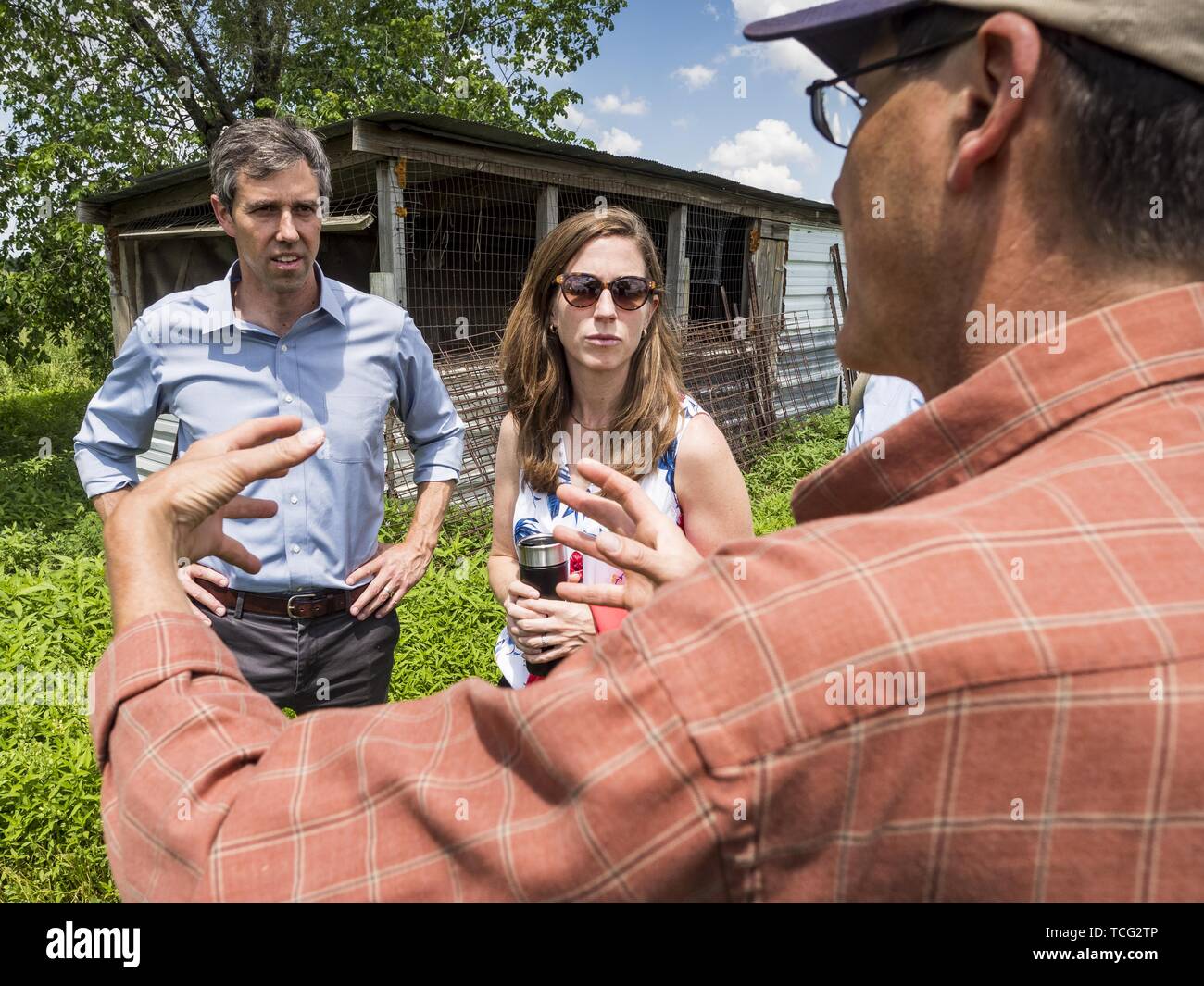 Iowa, USA. 07th June, 2019. BETO O'ROURKE, left, his wife, AMY O'ROURKE, and MATT RUSSELL talk while they tour Russell's farm, Coyote Run Farm. O'Rouke toured Coyote Run Farm in Lacona Friday. He talked to Russell, the farm's co-owner, about the impact of President Trump's tariffs on Iowa farmers and how climate change was changing American agriculture. O'Rourke, running to be the 2020 Democratic nominee for the US Presidency, has made climate change a central part of his campaign. Iowa traditionally hosts the the first selection event of the presidential election cycle. Credit: ZUMA Press, In Stock Photo
