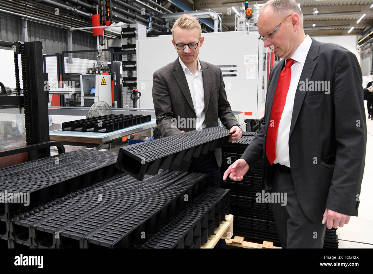 FILED - 10 May 2019, Schleswig-Holstein, Büdelsdorf: Iver Ahlmann, managing partners of ACO, (l-r), and Jens-Uwe Paasch, CFO of the company, stand in a production hall of ACO, one of the world market leaders for drainage technology. With its subsidiary north of London in particular, the group is preparing for the unpredictable consequences of the UK's withdrawal from the EU. (Zu dpa ""Brexmix"" protects against Brexit") Photo: Carsten Rehder/dpa Stock Photo