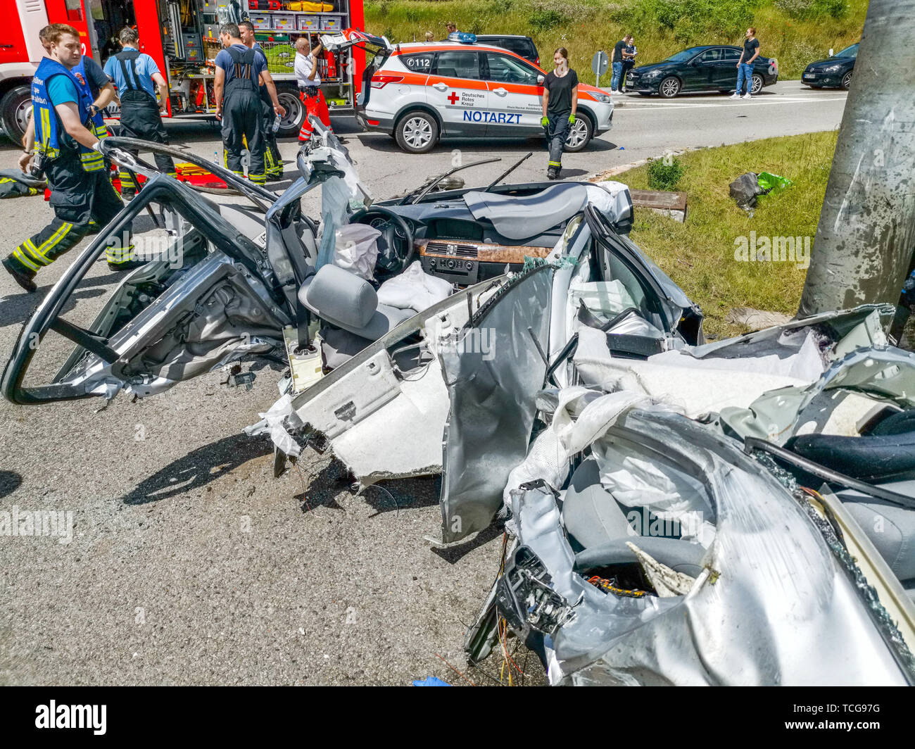 Waldorf Wiesloch, Germany. 08th June, 2019. Helpers are standing behind the wreckage of a car on a country road after a traffic accident. The driver was trapped in his completely destroyed vehicle and had to be rescued by the fire brigade. He came to the hospital with life-threatening injuries. A 54-year-old girl whose car was involved in the accident was injured more easily. (Zu dpa 'Serious accident near Walldorf - probably frenzy in the game') Credit: Julian Buchner/Einsatz-Report24/dpa/Alamy Live News Stock Photo