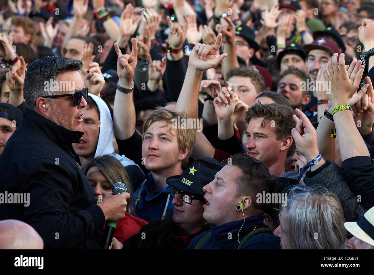 Nürburg, Germany, 08th June, 2019. Ken Casey (l), singer and bassist of the US-American folk-punk band 'Dropkick Murphys', sings with his fans in front of the main stage of the open-air festival 'Rock am Ring'. On three days about 75 bands will perform on three stages in front of more than 80 000 spectators. Photo: Thomas Frey/dpa Credit: dpa picture alliance/Alamy Live News Stock Photo