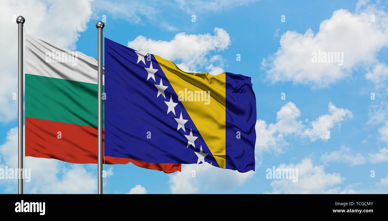 Bulgaria and Bosnia Herzegovina flag waving in the wind against white cloudy blue sky together. Diplomacy concept, international relations. Stock Photo