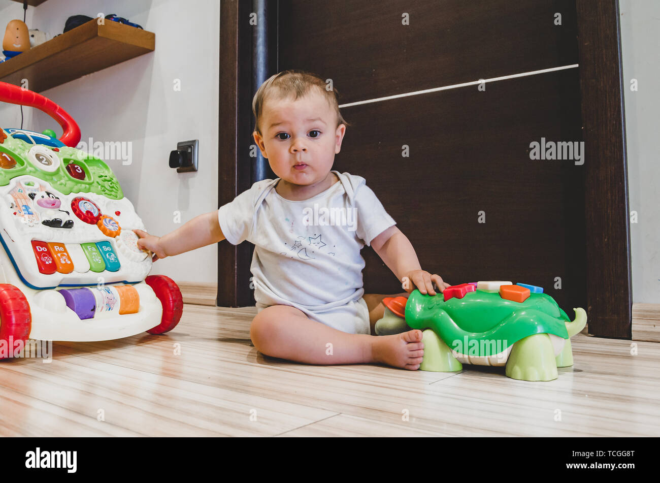 cute seven months old baby boy playing with educational toys on the