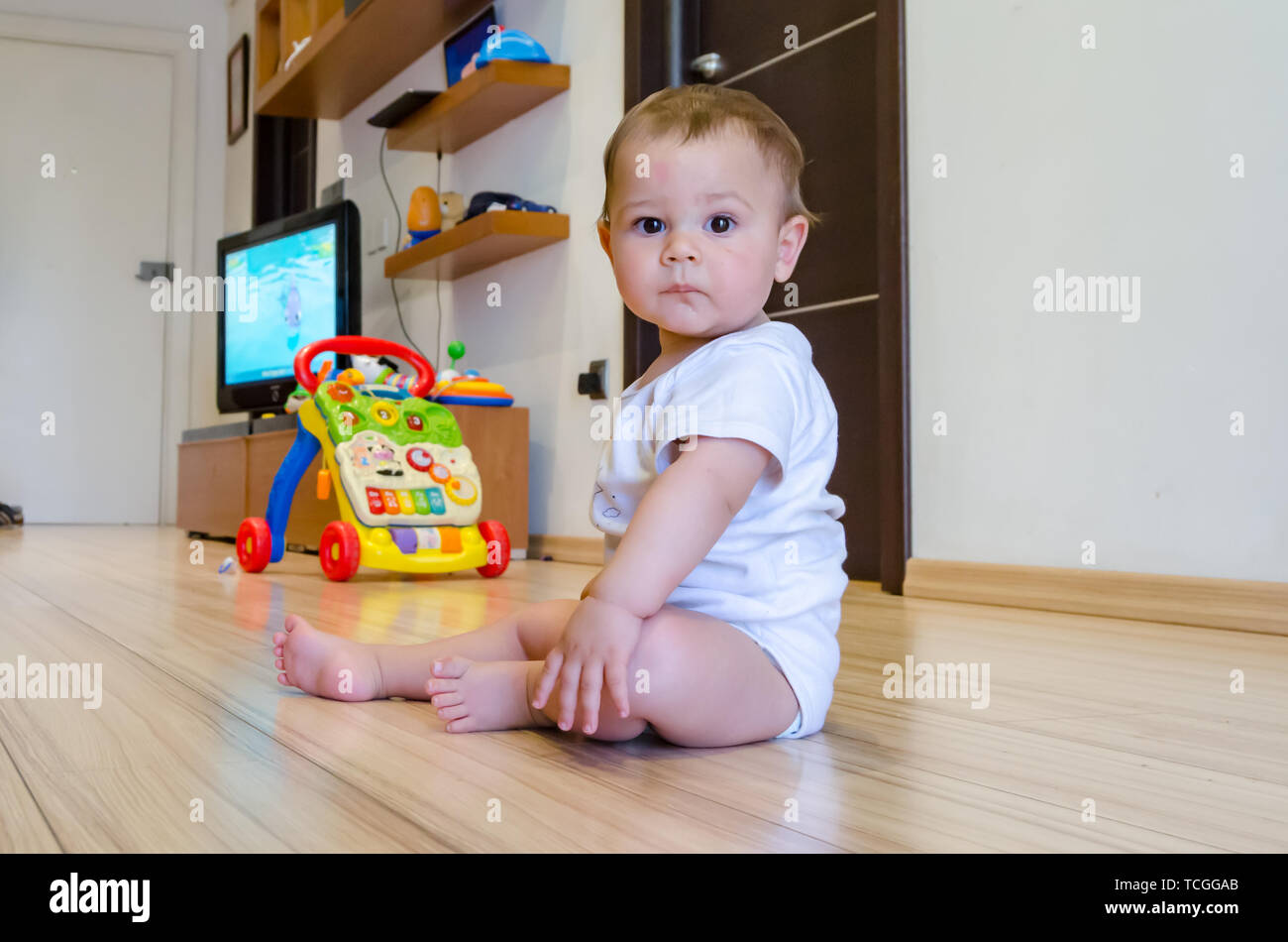 cute seven months old baby boy playing with educational toys on the