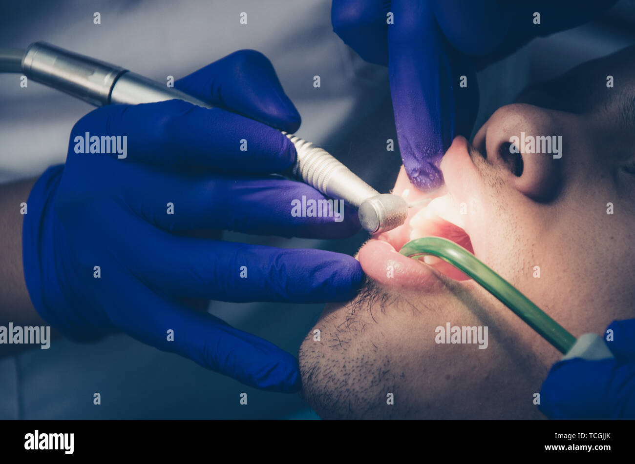 Seated young man is being examined his teeth by a dentist Stock Photo
