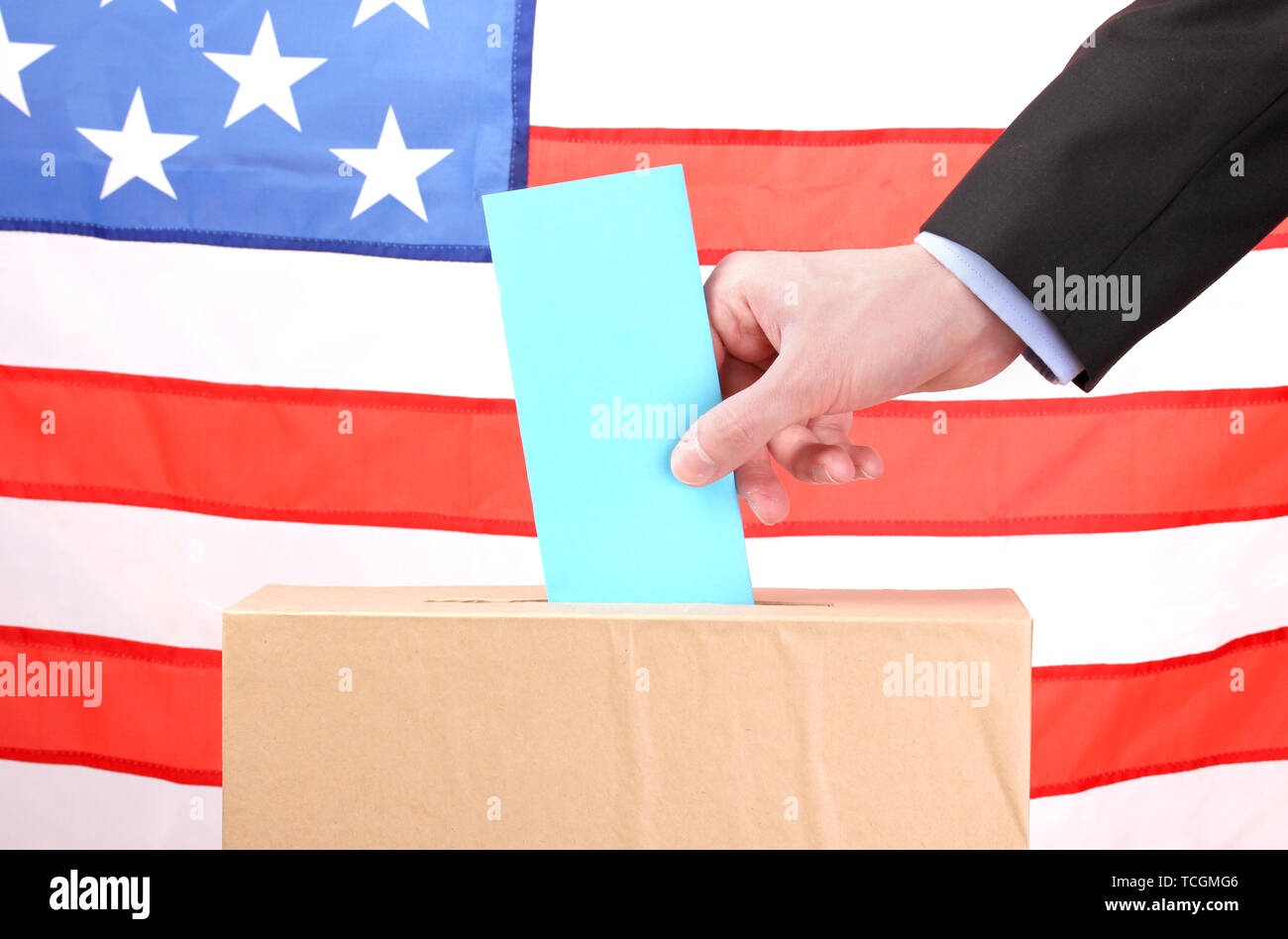 Hand with voting ballot and box on Flag of USA Stock Photo - Alamy
