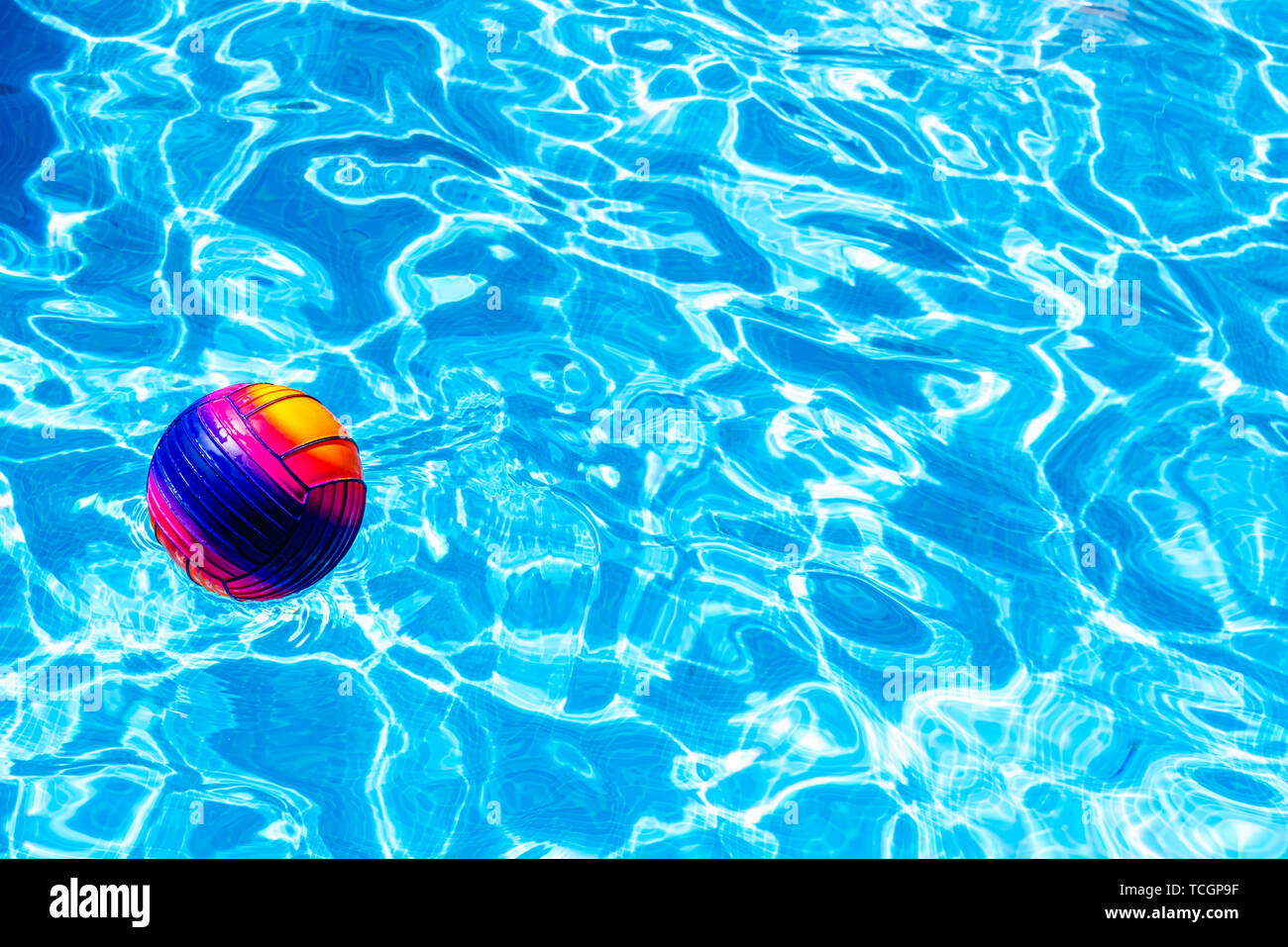 Colorful ball floating on a pool. Stock Photo