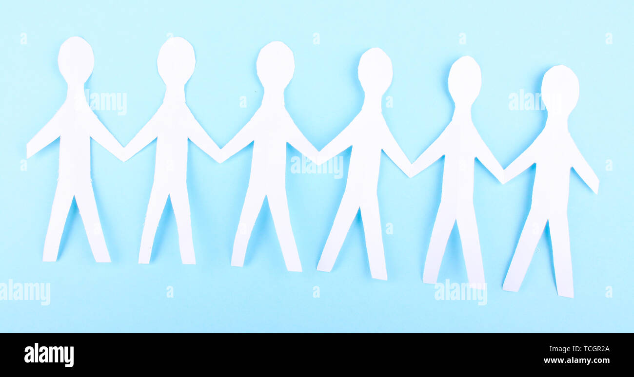 Paper people on blue background Stock Photo - Alamy