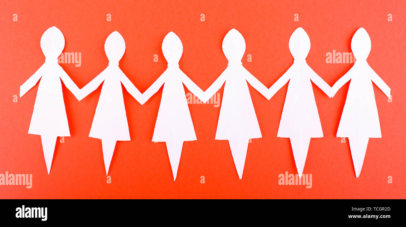 Paper people on red background Stock Photo - Alamy
